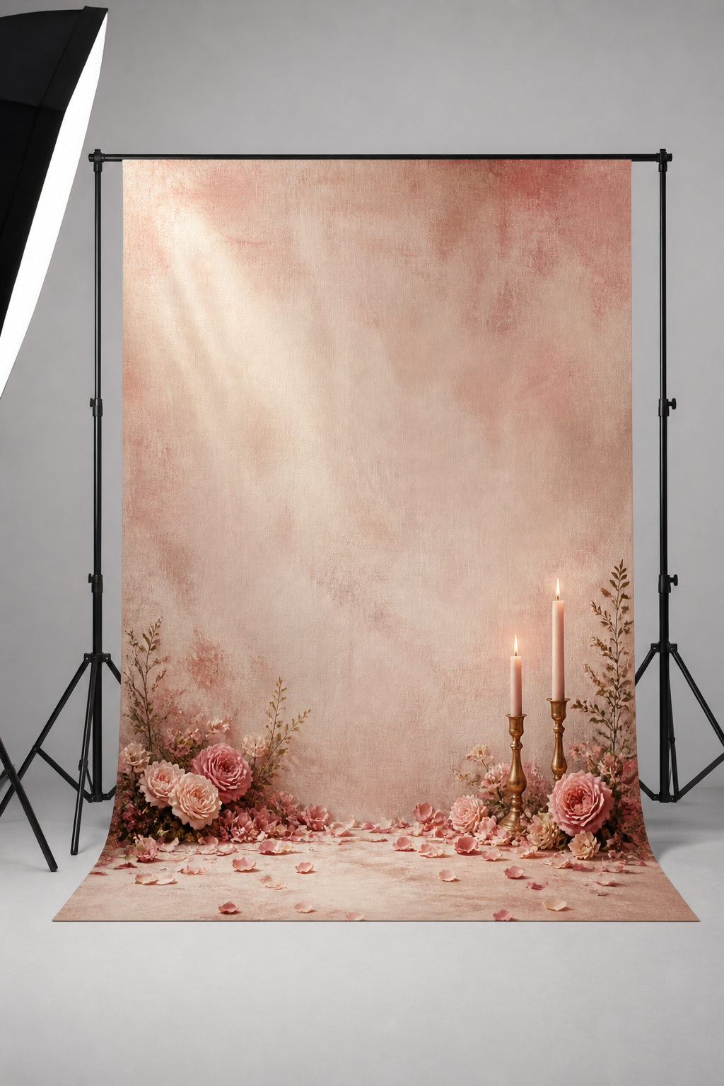 Blush rose petal and candlelight photography backdrop printed on matte microfiber, shown hanging on a backdrop stand in a studio