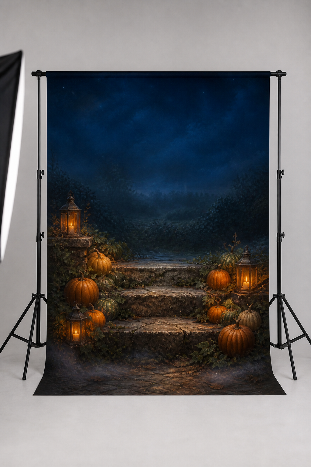 Candlelit stone steps with pumpkins photography backdrop printed on matte microfiber, shown hanging on a backdrop stand in a studio